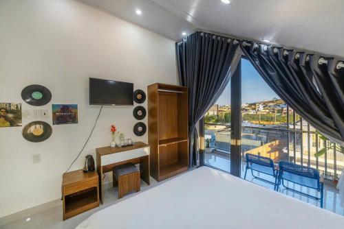 a bedroom with a large window with a view at Happy Home in Da Thanh