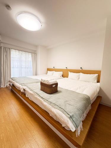 a large bed in a room with a large window at サムティ扇町 in Osaka