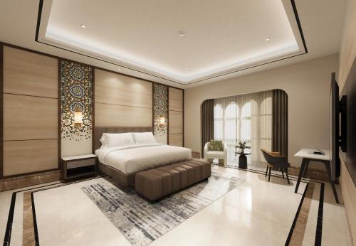 a bedroom with a bed and a desk at Lotusa Batulicin by Swiss-Belhotel in Mantaak
