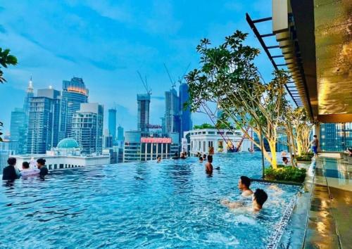 a swimming pool with a city skyline in the background at Residence Axon Bukit Bintang by The Family Suites in Kuala Lumpur