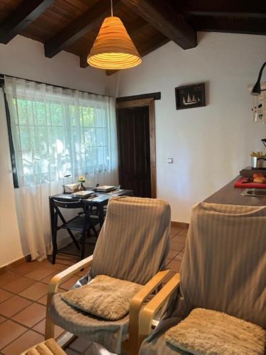 a living room with chairs and a dining room table at Casa rural Paraje de Yuste in Cuacos de Yuste