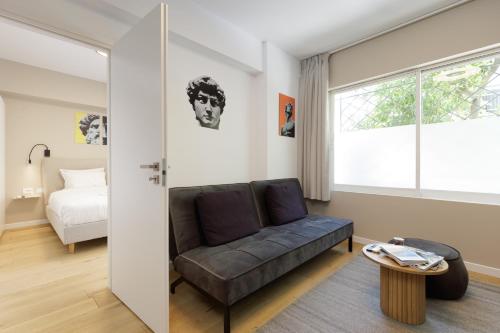 a living room with a couch and a bed at Incanto Boutique Suites - Koukaki in Athens