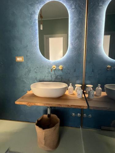 a bathroom with a sink and a large mirror at Dionisio 7 in Pescara