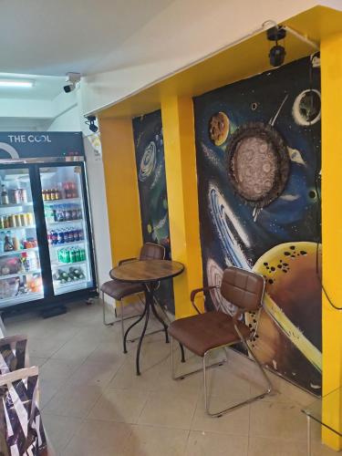 a room with two tables and chairs in a store at Come again Coffee and Hostel in Jomtien Beach