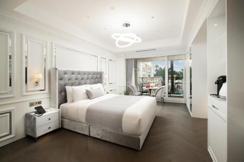 a bedroom with a large bed and a balcony at The Siena PRIMO in Seogwipo