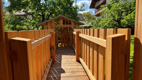 a wooden fence with a gazebo in a yard at Appartements Schweiberer in Ried im Zillertal