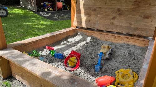 a sandbox with some toys in the sand at Appartements Schweiberer in Ried im Zillertal