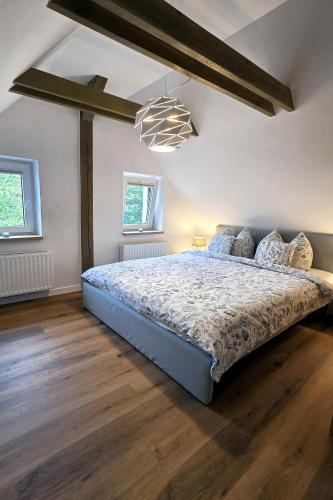a bedroom with a large bed in a room at Willa Muszelka - Apartamenty in Świnoujście