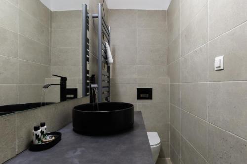 a bathroom with a sink and a toilet at Incanto Boutique Suites - Koukaki in Athens