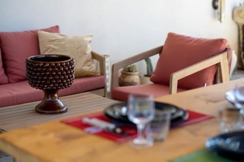 a table with a bowl and a wine glass on it at Collemeti - Country House in Noto