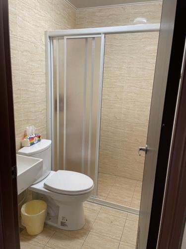 a bathroom with a toilet and a shower at Hello Guesthouse in Lugang