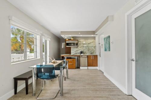 a dining room and kitchen with a table and chairs at Spacious APT on South Beach Roof Top Pool & Bar in Miami Beach