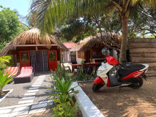 a scooter parked in front of a house at The Tasty Tuna Cabana in Arugam Bay