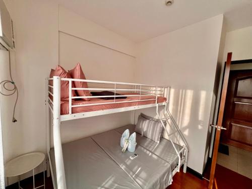 a small bedroom with a bunk bed with two beds at 3 Bedroom Spacious Davao Condo in Davao City