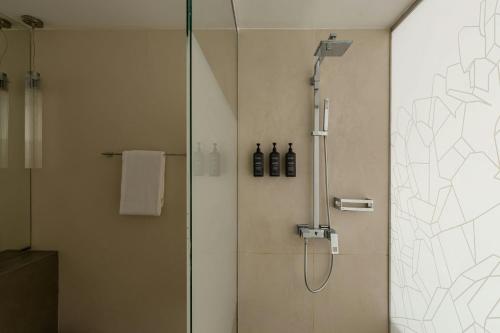 a shower in a bathroom with a glass door at Sheraton Baku Intourist in Baku