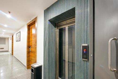 a hallway with a glass door in a building at Premium Lee Premier in New Delhi