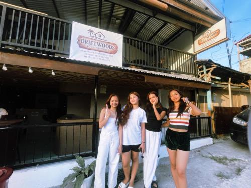 a group of women standing outside of a building at Driftwoods Lodging House in Moalboal