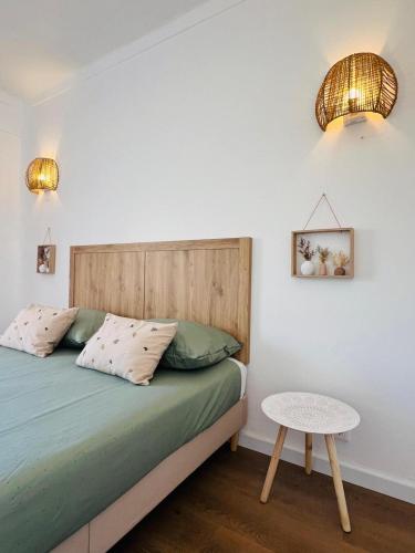 a bedroom with a bed and a table at Apartamento Brisa Vicentina- Odeceixe in Odeceixe