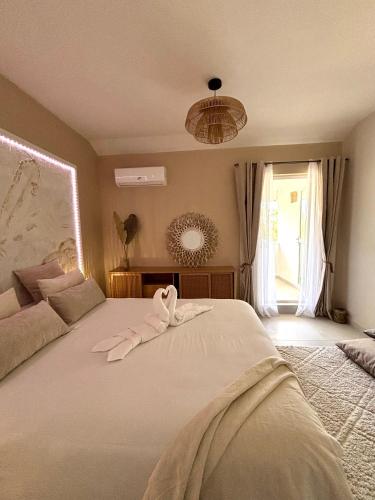 a bedroom with a bed with a towel on it at T2 duplex- piscine- vue mer in Saint-Paul