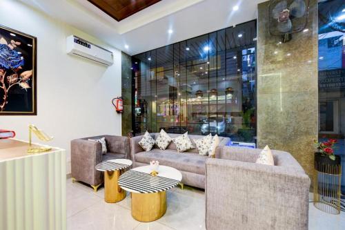 a living room with a couch and a table at Airport Le Premier, New Delhi in New Delhi