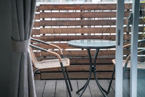 a table and two chairs on a balcony at UNPLAN Kagurazaka in Tokyo