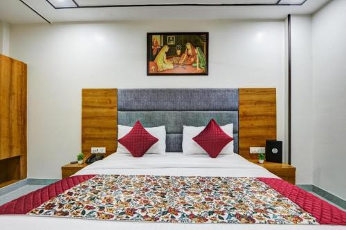 a bedroom with a large bed with red pillows at Airport Le Premier, New Delhi in New Delhi