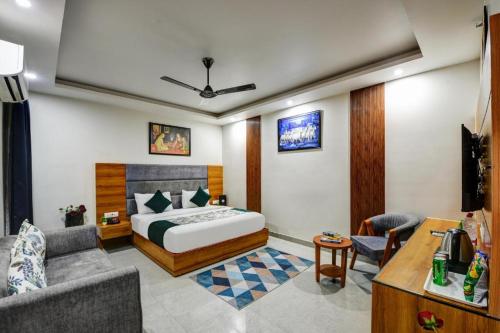 a hotel room with a bed and a couch at Airport Le Premier, New Delhi in New Delhi