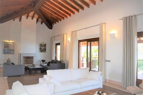a living room with a white couch and a fireplace at Andratx Villa: A Stylish Oasis of Relaxation, 1043 in Andratx