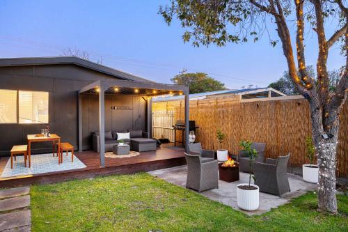 a backyard of a house with a patio at The Eighth - Pet Friendly in Rosebud