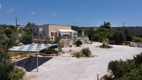 a house with a solar array in a yard at Villa Bella Vista - VIP by Salento Prime in Marina di Pescoluse