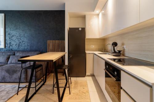 a small kitchen with a table and a refrigerator at BW Cityline Residences in Belgrade