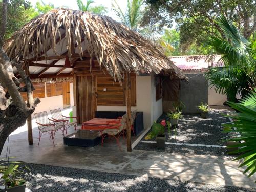 a hut with chairs and a thatched roof at The Tasty Tuna Cabana in Arugam Bay