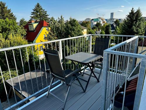 a table and two chairs on a balcony at AJO Apartments - Vetmed - Self-Check-in in Vienna