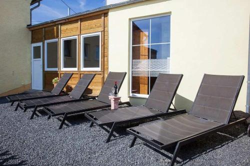 a row of chairs sitting outside of a building at The Great View Sauna & more in Harscheid
