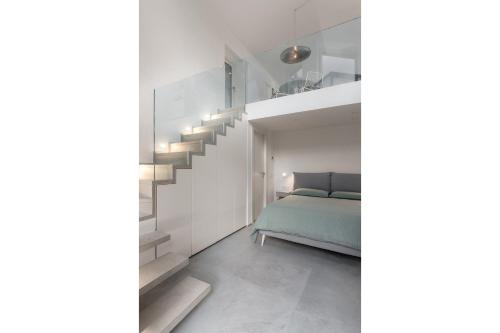 a bedroom with a bed and a staircase at Via dei Monti in Nesso