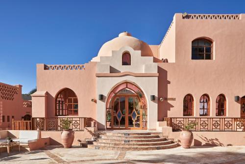 a large building with stairs in front of it at Hotel Sultan Bey Resort in Hurghada