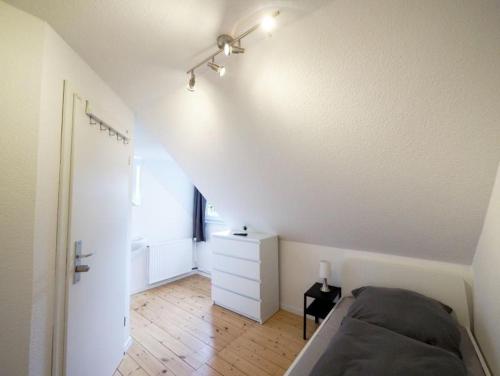 a white bedroom with a bed and a white dresser at Monteurwohnung-fuer-6-Pers-mit-WLAN-Kueche-TV-Bad-Oldesloe-Naehe-Hamburg-Naehe-Luebeck in Bad Oldesloe
