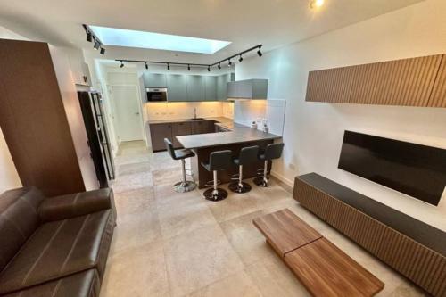 a kitchen and living room with a table and a couch at 4 Bedroom house with Ensuite.contractors welcome in Huddersfield