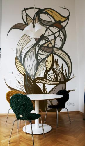 a table and two chairs in front of a wall at aeki CITY in Vienna