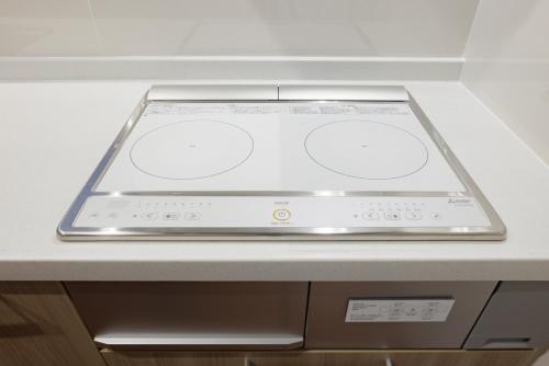 an electronic device sitting on top of a counter at Sakuramachi Villa Projector BBQ Free parking 2 Bed Rooms in Kumamoto