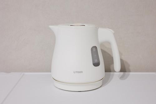 a white electric kettle sitting on top of a counter at Sakuramachi Villa Projector BBQ Free parking 2 Bed Rooms in Kumamoto
