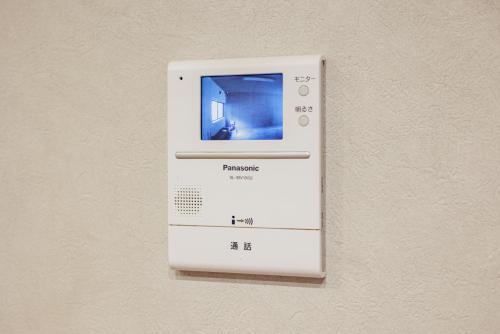 a white object is attached to a wall at Sakuramachi Villa Projector BBQ Free parking 2 Bed Rooms in Kumamoto