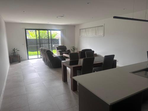 a room with chairs and tables in a room with a window at Queen Room in Modern, Guildford House - OR7 in Guildford
