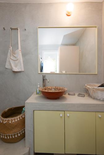 a bathroom with a sink and a mirror at Sifnos Hideaway in Sifnos