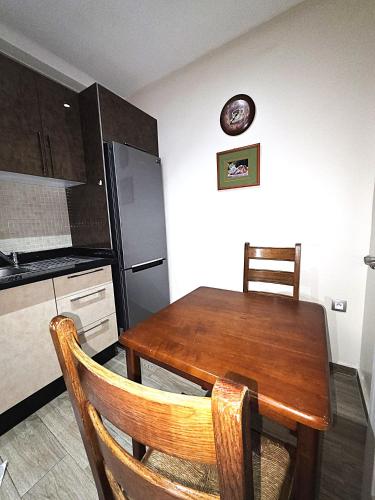 a kitchen with a wooden table and a refrigerator at Apartment in Agadir in Agadir