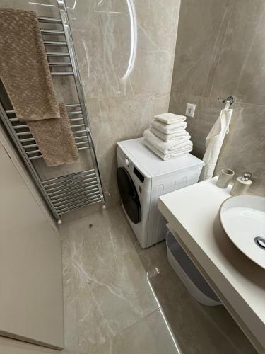 a bathroom with a washing machine and a sink at Azure Ionian in Agios Georgios