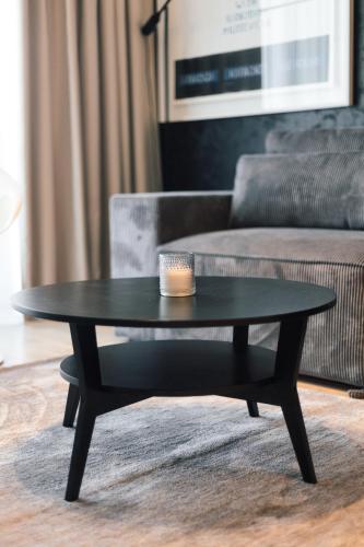 a black coffee table in a living room with a couch at BW Cityline Residences in Belgrade