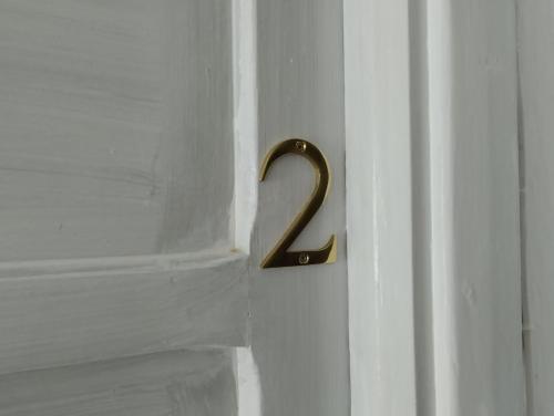 a doorhandle with a number two on a white door at Gorofai in Bitti