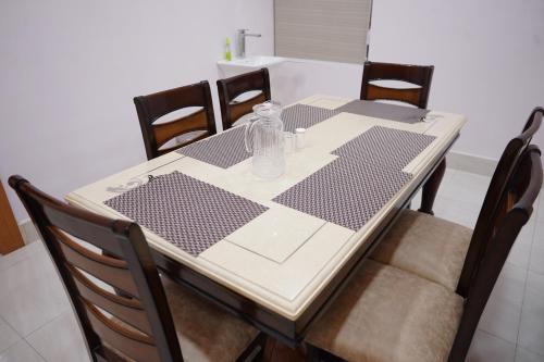 a dining room table with a glass bottle on it at Veena Stay and Cafe Restaurant in Bhubaneshwar