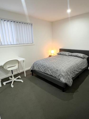 a bedroom with a bed and a desk and a chair at Queen Room in Peaceful and Modern House - OR8 in Guildford